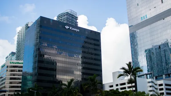 A large glass-fronted office building with the Kaseya corporate logo emblazoned on it.