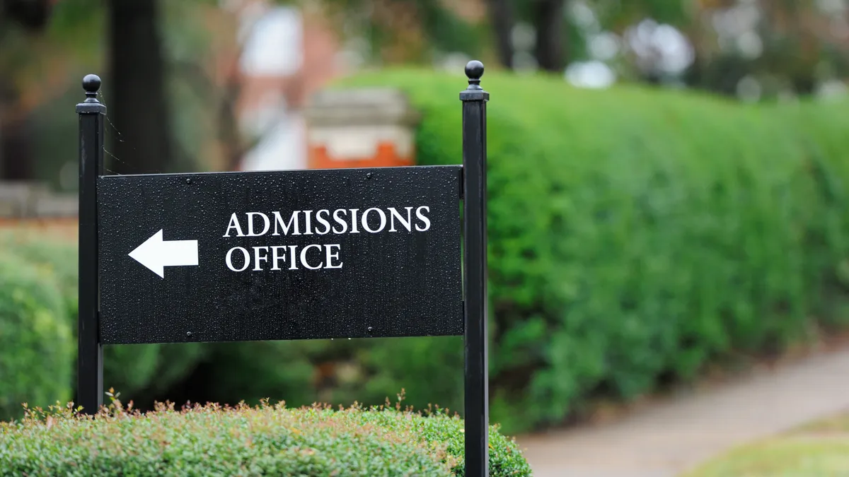 A sign advertises a college admissions office.