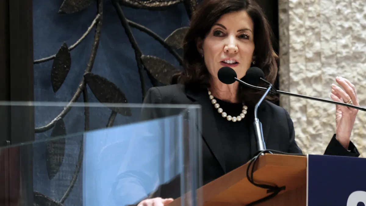 New York Gov. Kathy Hochul speaks at a podium.