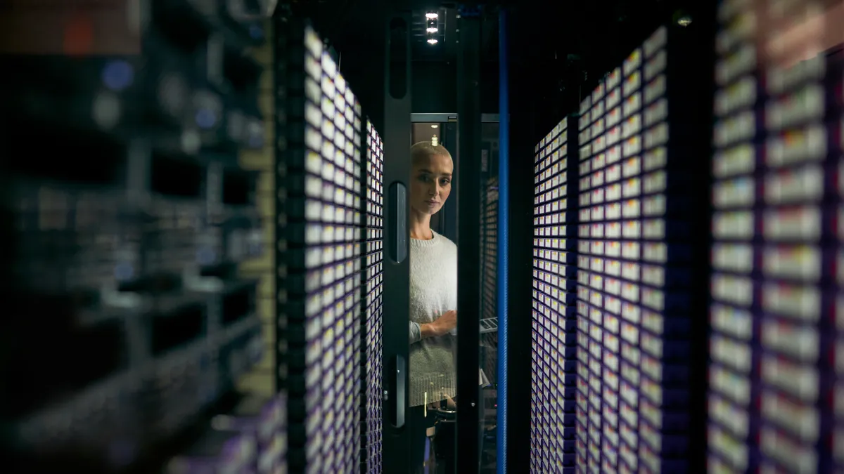 A woman monitoring data center machines.