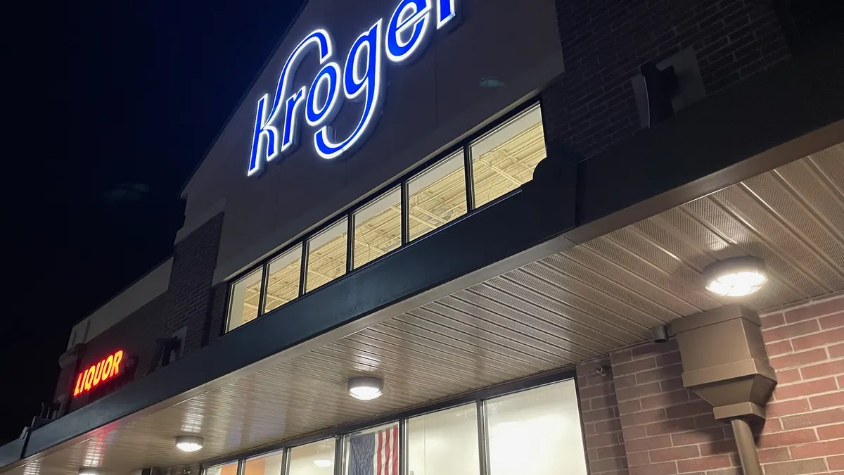 Exterior of a grocery store at night.