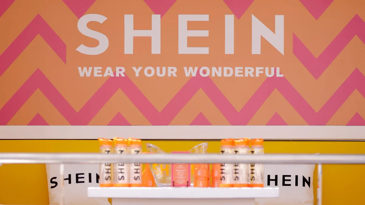 A Shein store is pictured, featuring brightly colored walls and water bottles.