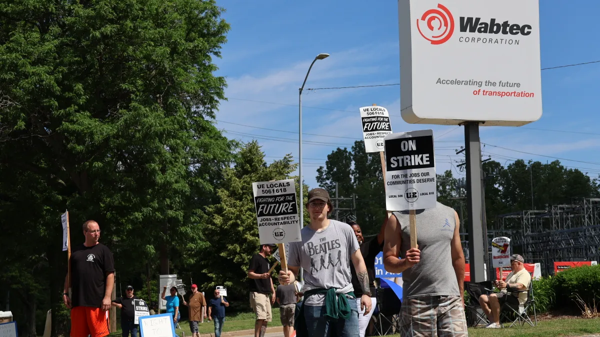 People striking at in front of Wabtec plant in Erie, Pennsylvania on a sunny day.