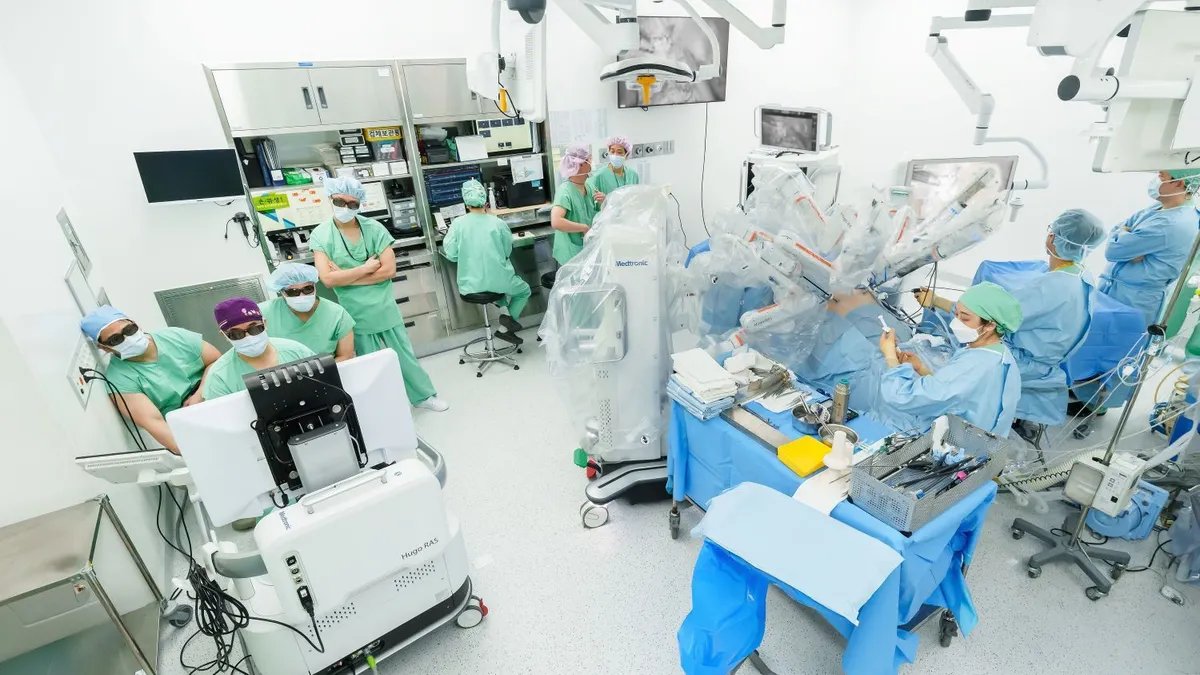 Medtronic's Hugo robotic surgery system is shown in an operating room in Seoul, South Korea, with a surgical team.