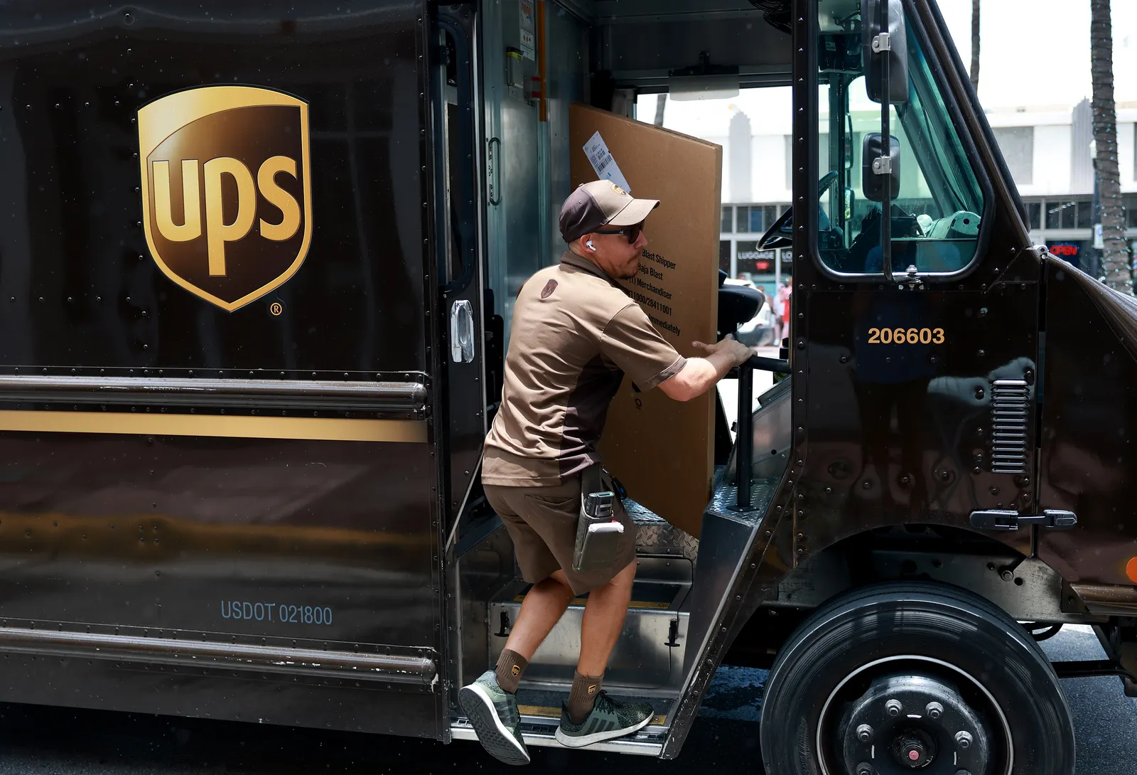 A UPS driver makes a delivery.