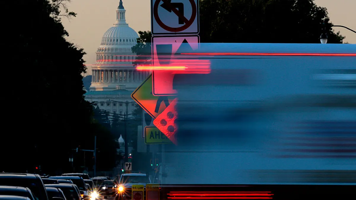 Morning traffic passes in front of the U.S. Capitol on Oct. 1, 2025 in Washington.