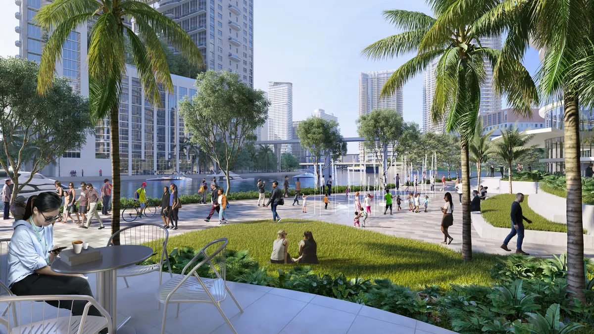 A rendering of the Miami Riverbridge project shows diners at tables on an outdoor terrace and pedestrians walking on sidewalks along the Miami River.