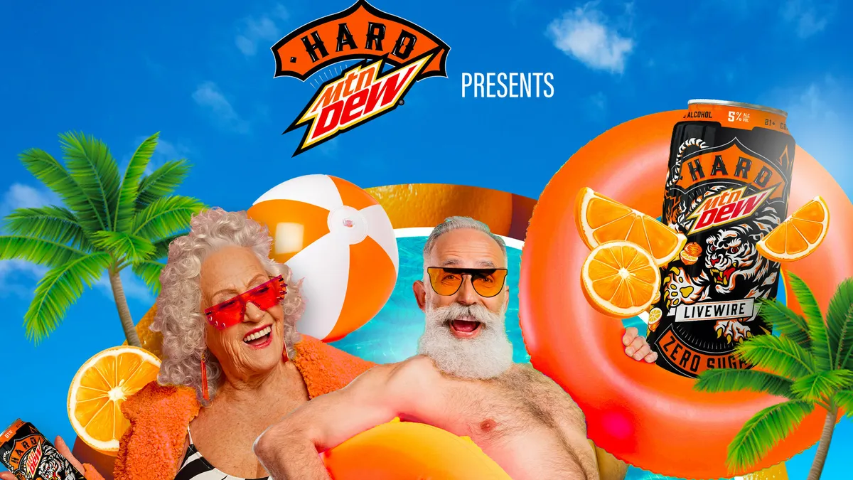 An older couple plays in clear blue water to promote Hard Mtn Dew's retirement community contest.