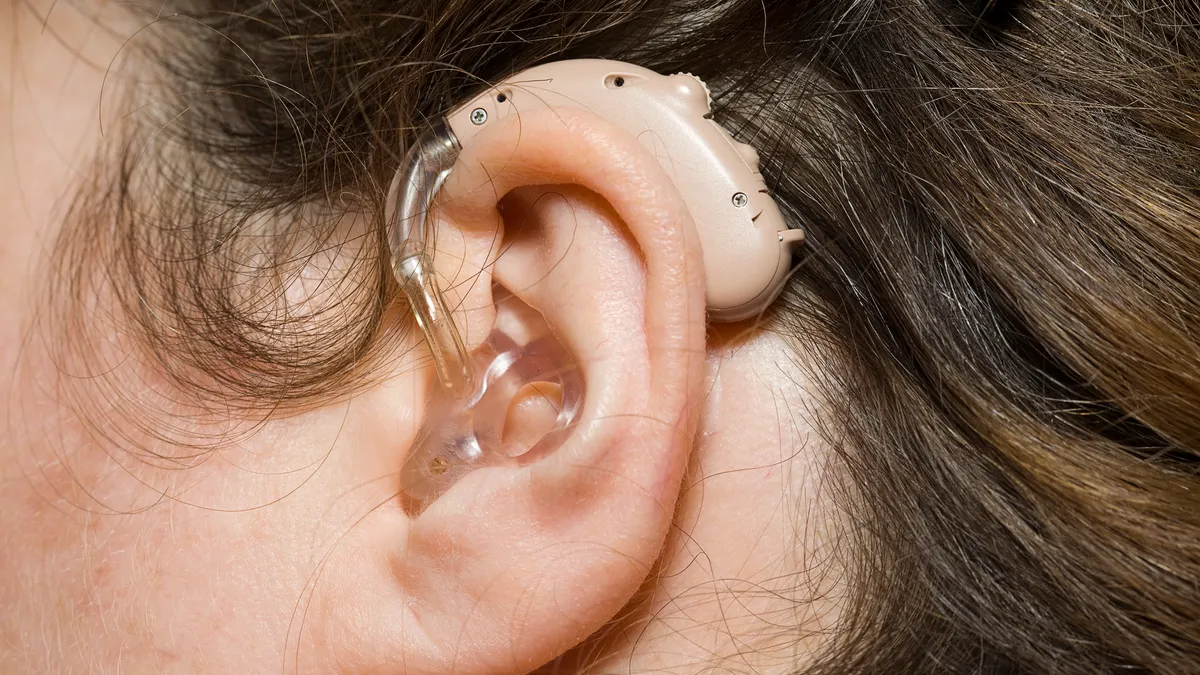 Close up of woman wearing digital hearing aid