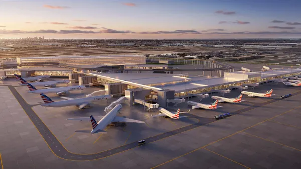 Aerial view of DFW's new and expanded Terminal F, ringed with airplanes.