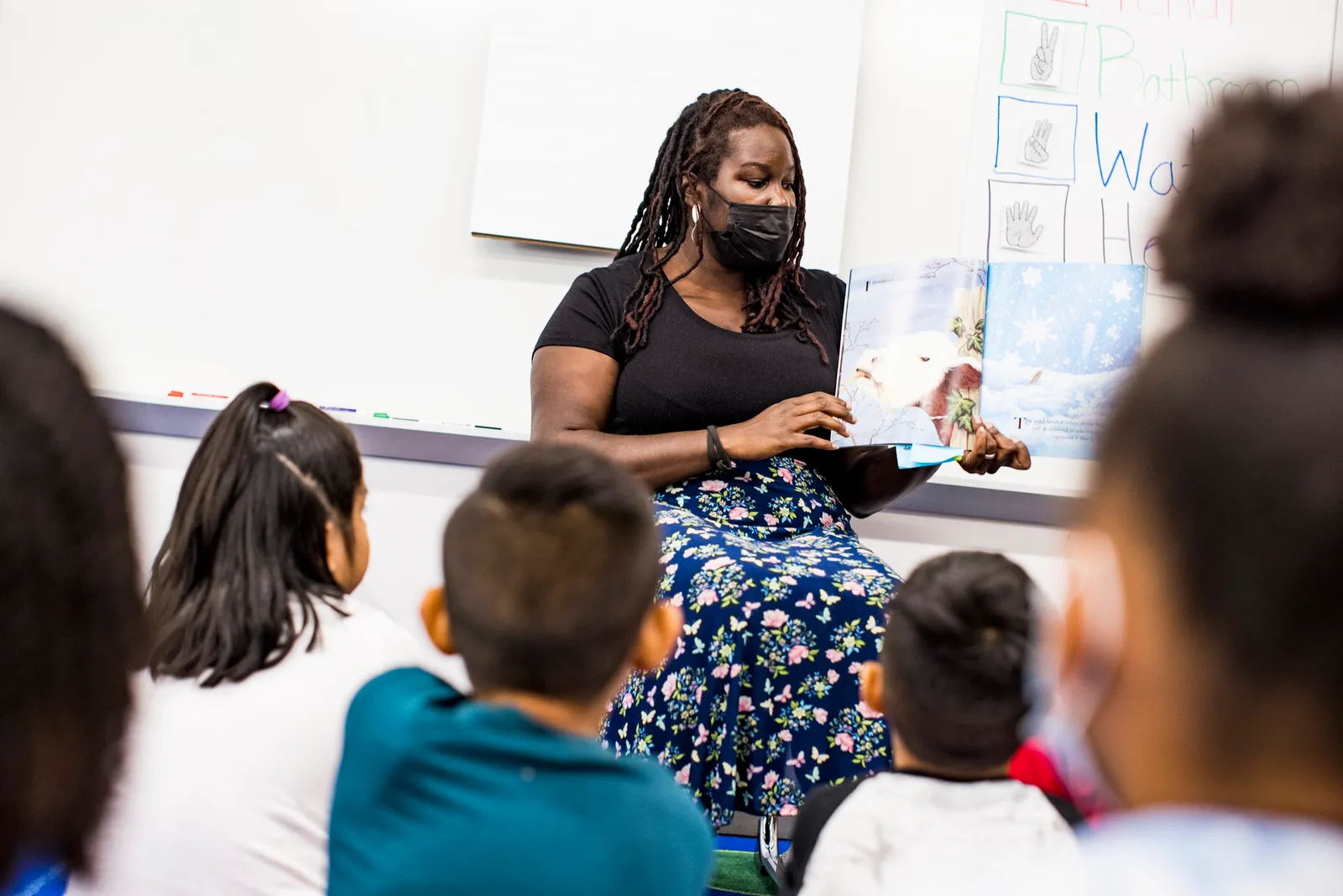 BCTR Resident and BEEC member, Joi Botchway, reads in front of students at Holabird Academy in Baltimore City Public Schools.