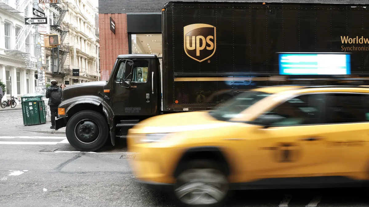 A shot of blurred taxi in front of a UPS truck