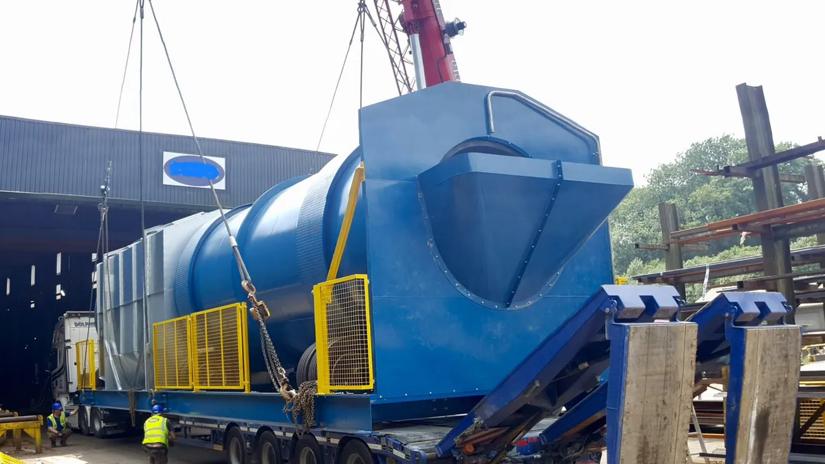 Equipment being loaded into industrial facility