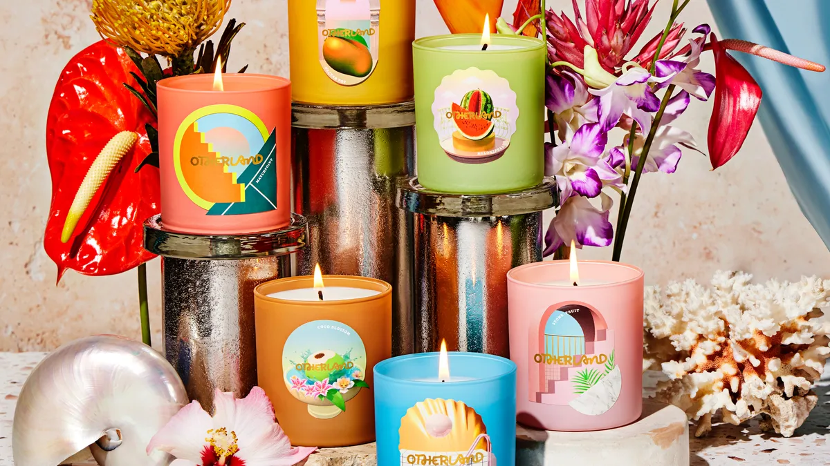 Several multi-colored candles are displayed from Otherland