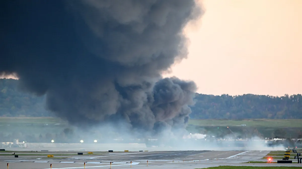 Fire and smoke mark where a UPS cargo plane crashed near Louisville Muhammad Ali International Airport on Nov. 4, 2025.