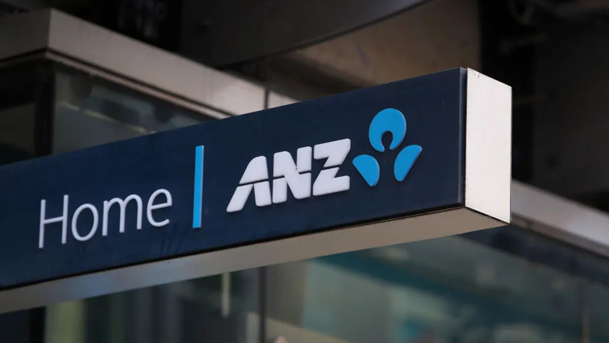 A blue sign with white letters reads "Home | ANZ" and the bank's logo