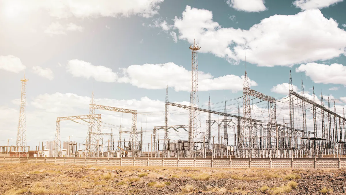 Large electrical substation in the desert against the blue sky.