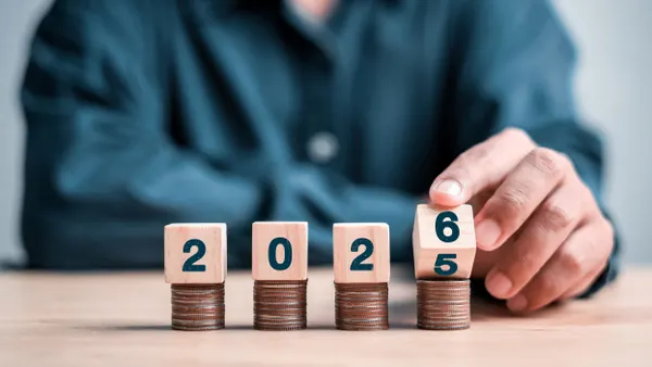 Four stacks of quarters, each with a number block to show 2026.