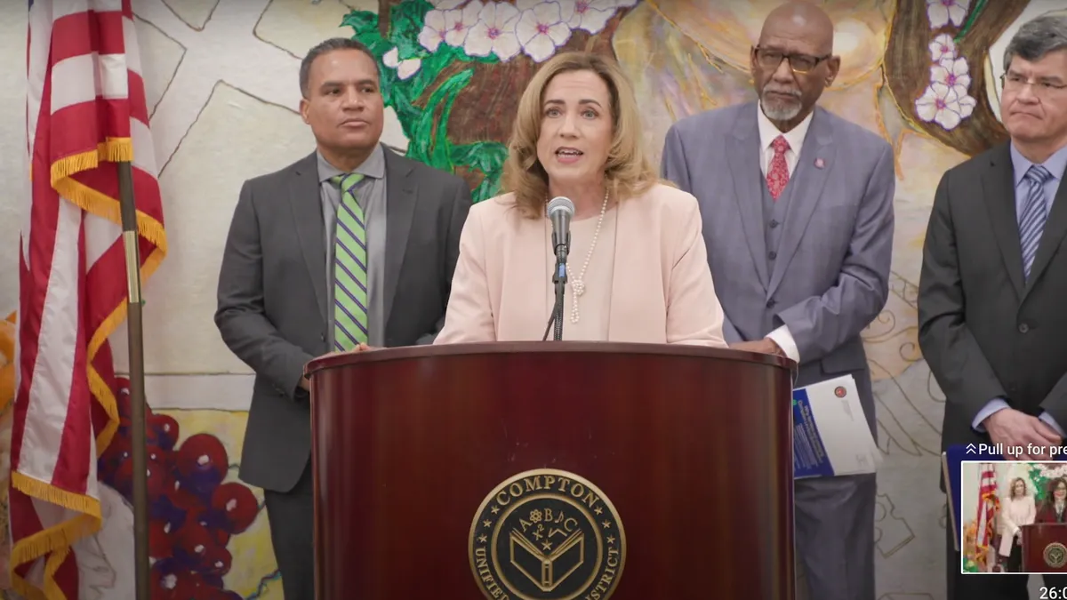 Los Angeles County Superintendent of Schools Debra Duardo speaks into a microphone