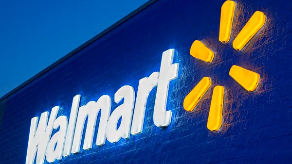 The exterior of a Walmart store at night