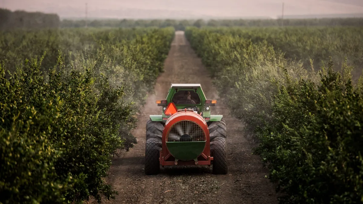 A farmer uses Smart Apply's technology to sustainably spray crops.