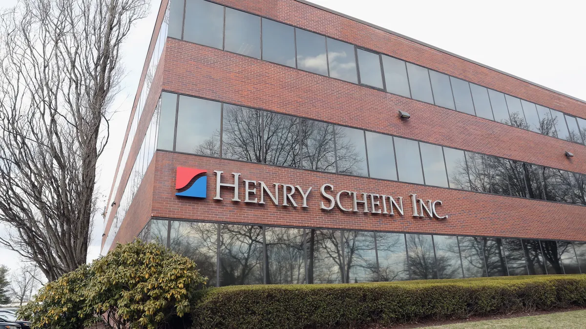 A brick building with a sign that says "Henry Schein Inc."