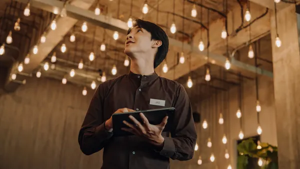 A hotel staffer holds a tablet.