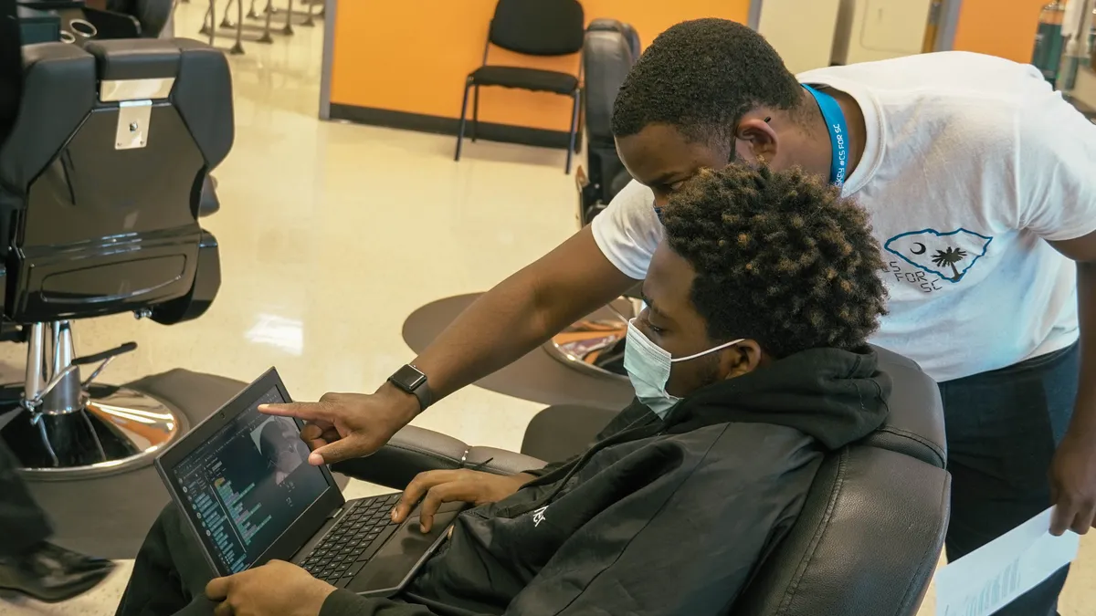 Students in Marwin McKnight's barbering class at Fairfield Career and Technical Center in South Carolina practice a new coding program to allows students to create hair designs.