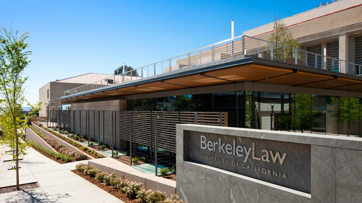 A stone sign in front of a building says "Berkeley Law."