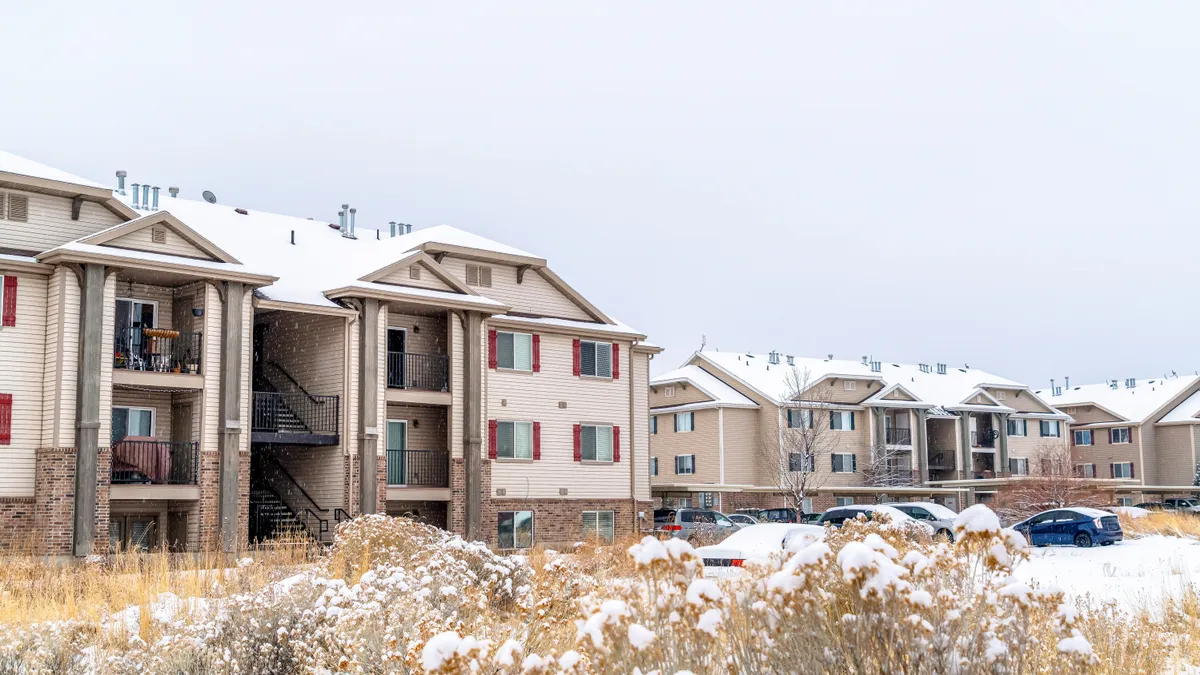 Apartment buildings and townhouses at a snowy neighborhood in winter season.