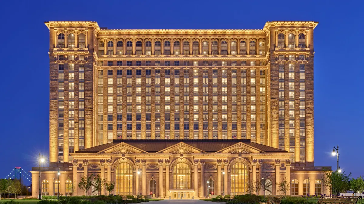 The exterior of the Michigan Central Station building with a dark blue sky in the background.