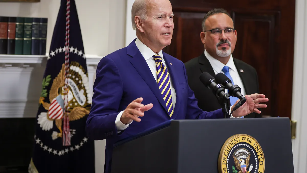 President Joe Biden stands behind a podium.