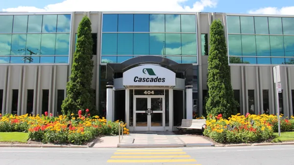 Outside view of an office building with a sign for Cascades paper.