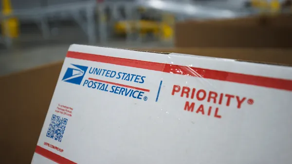 Close up view of a U.S. Postal Service priority mail shipping box.