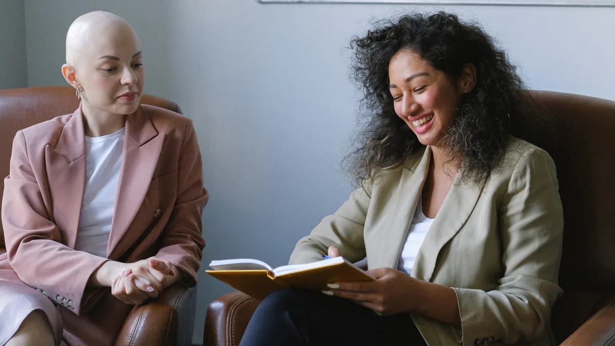 Two employees work together in an office