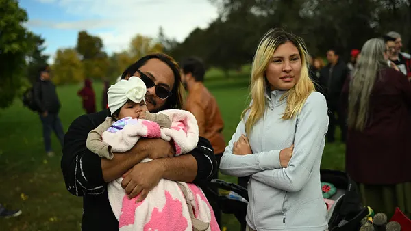 a man holds his baby daughter