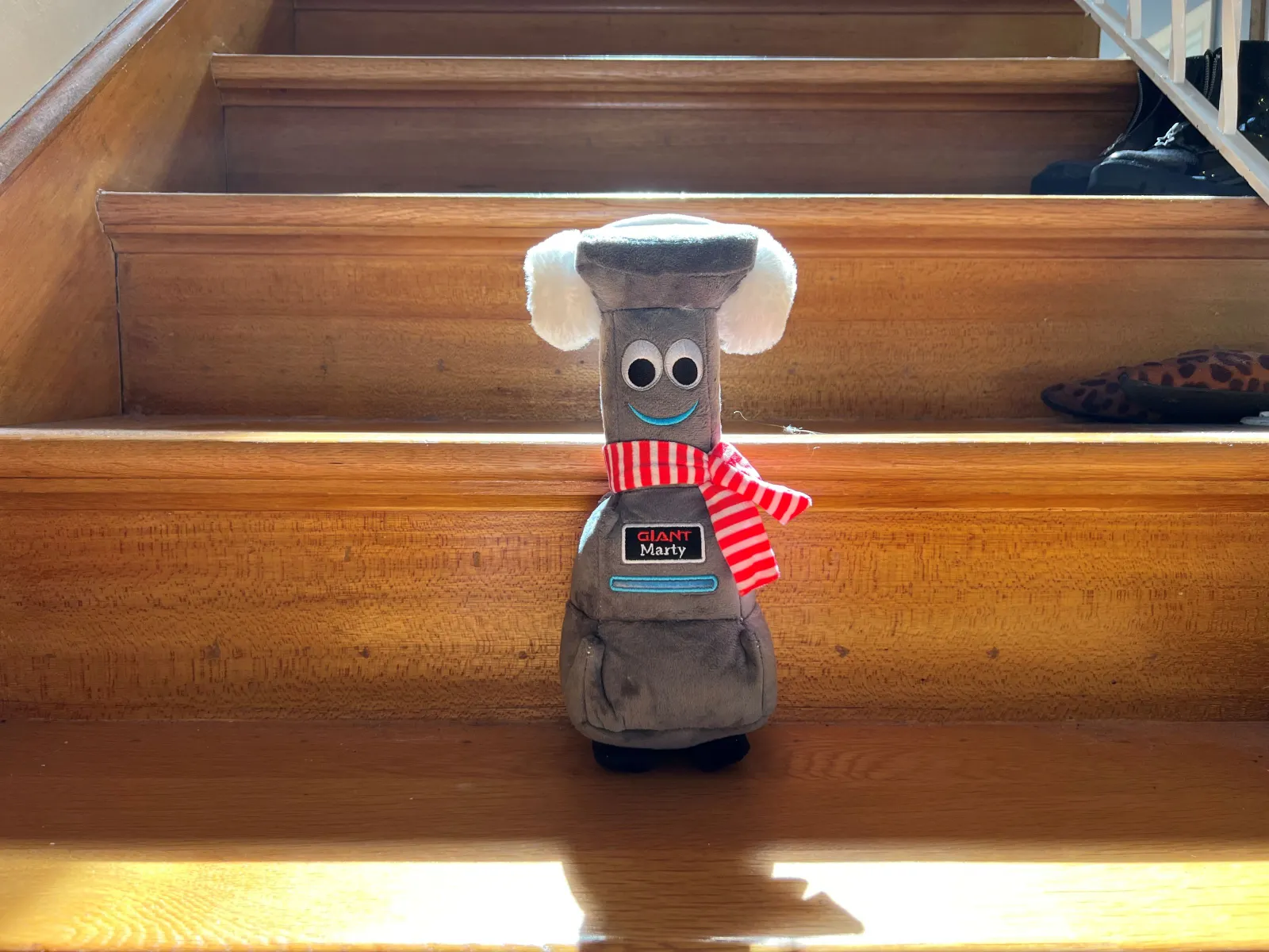 A plushie on a stair.
