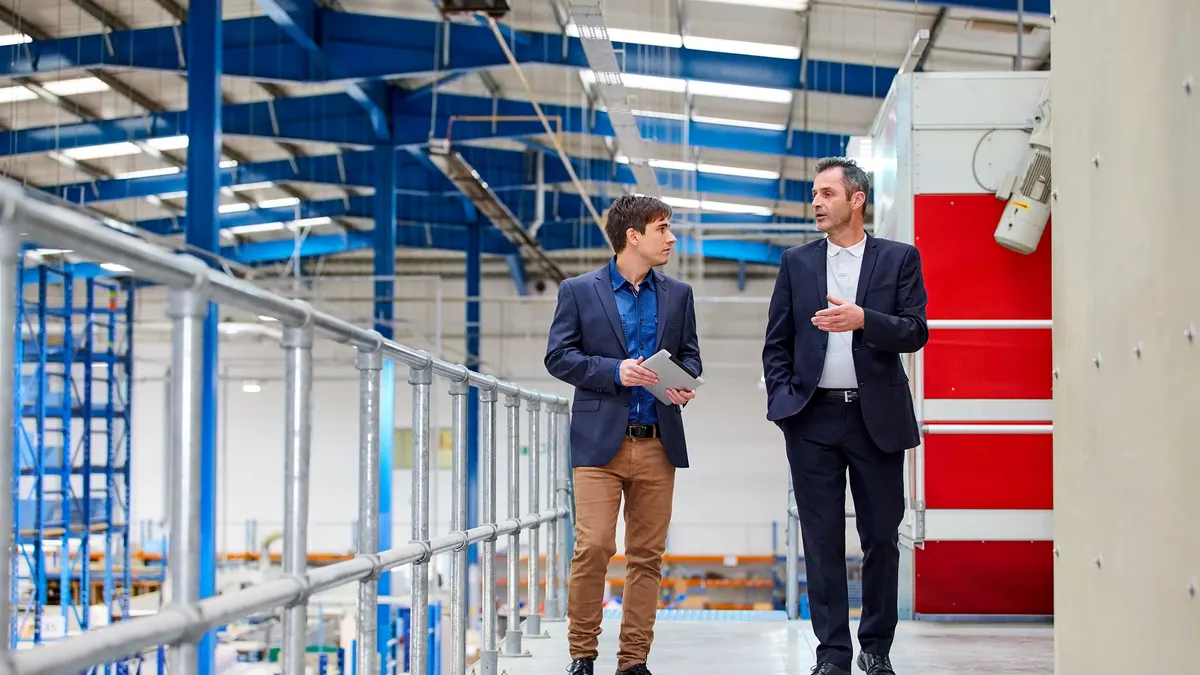 Two men consulting in a factory