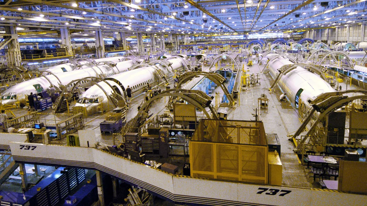 Fuselages sit in production plant.