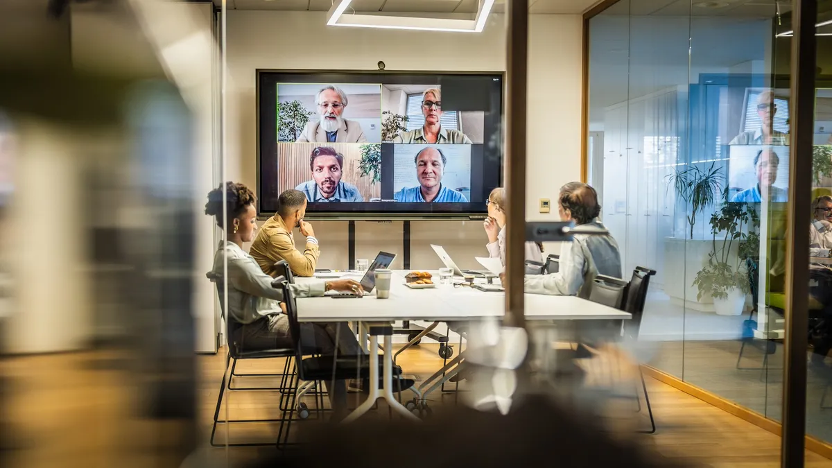 Business people attending a hybrid presentation