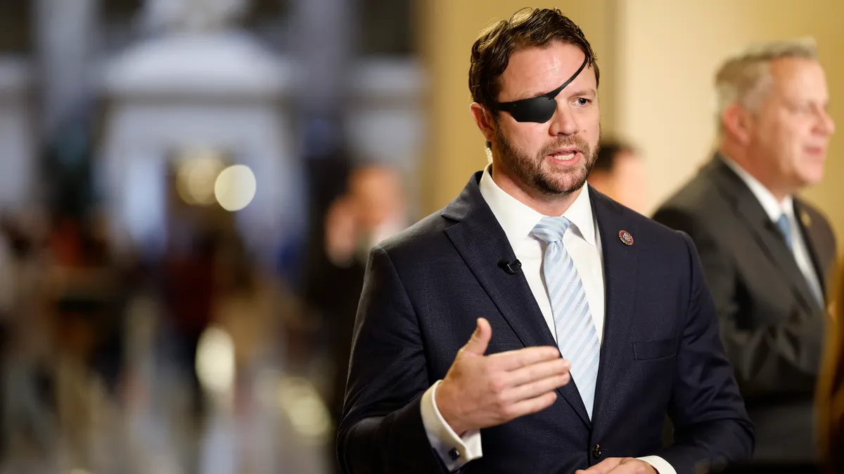 Rep. Dan Crenshaw speaks to reporters.