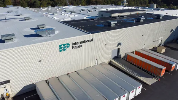 Aerial view of an industrial facility with an International Paper sign on the outside.