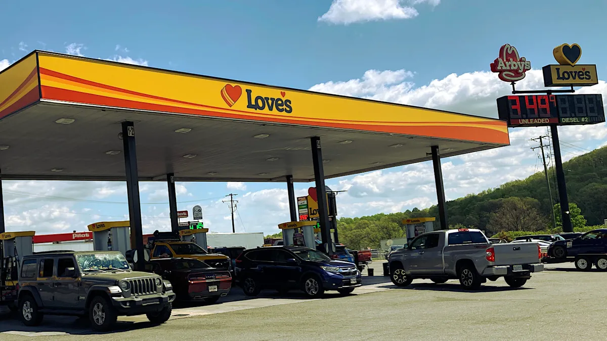 A photo of the forecourt of a gas station. The canopy reads "Love's."