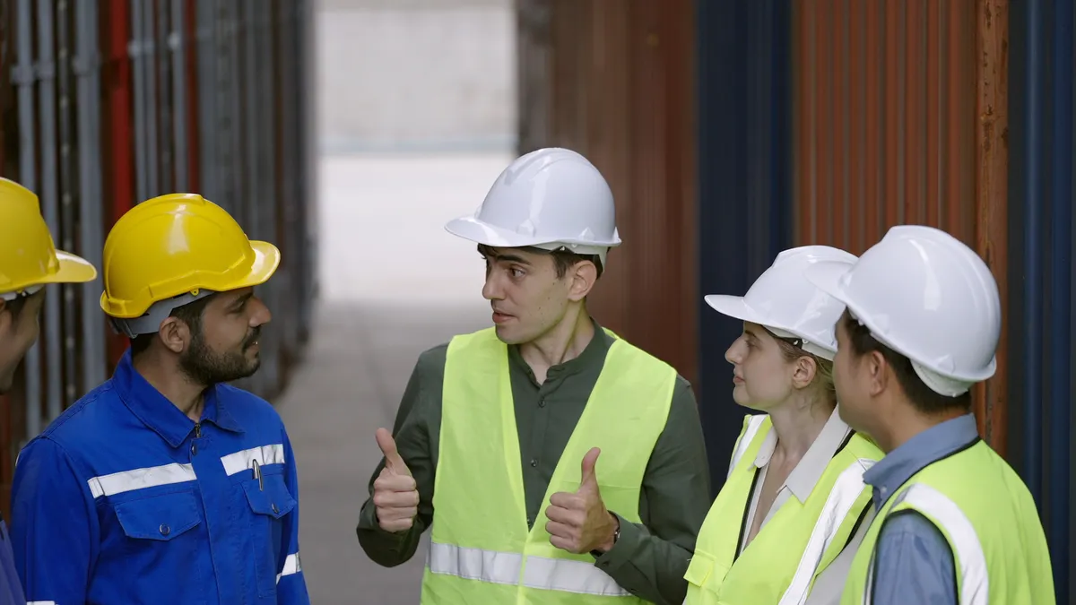 Multiracial worker doing a huddle together