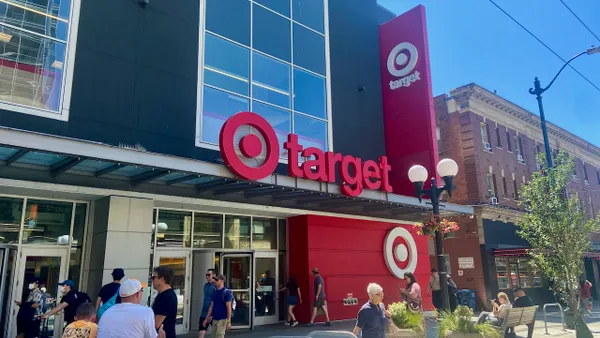 People walking past and into a store.