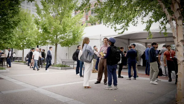 people gather outside of building during boston blockchain week
