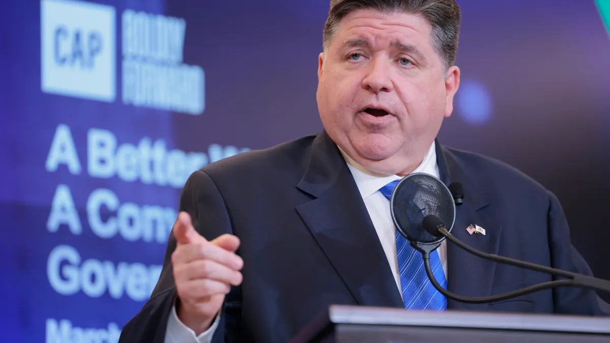 A man speaks at a podium.