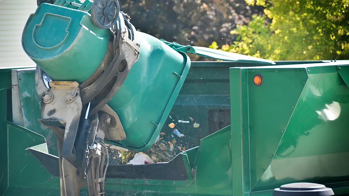 Garbage truck collecting waste