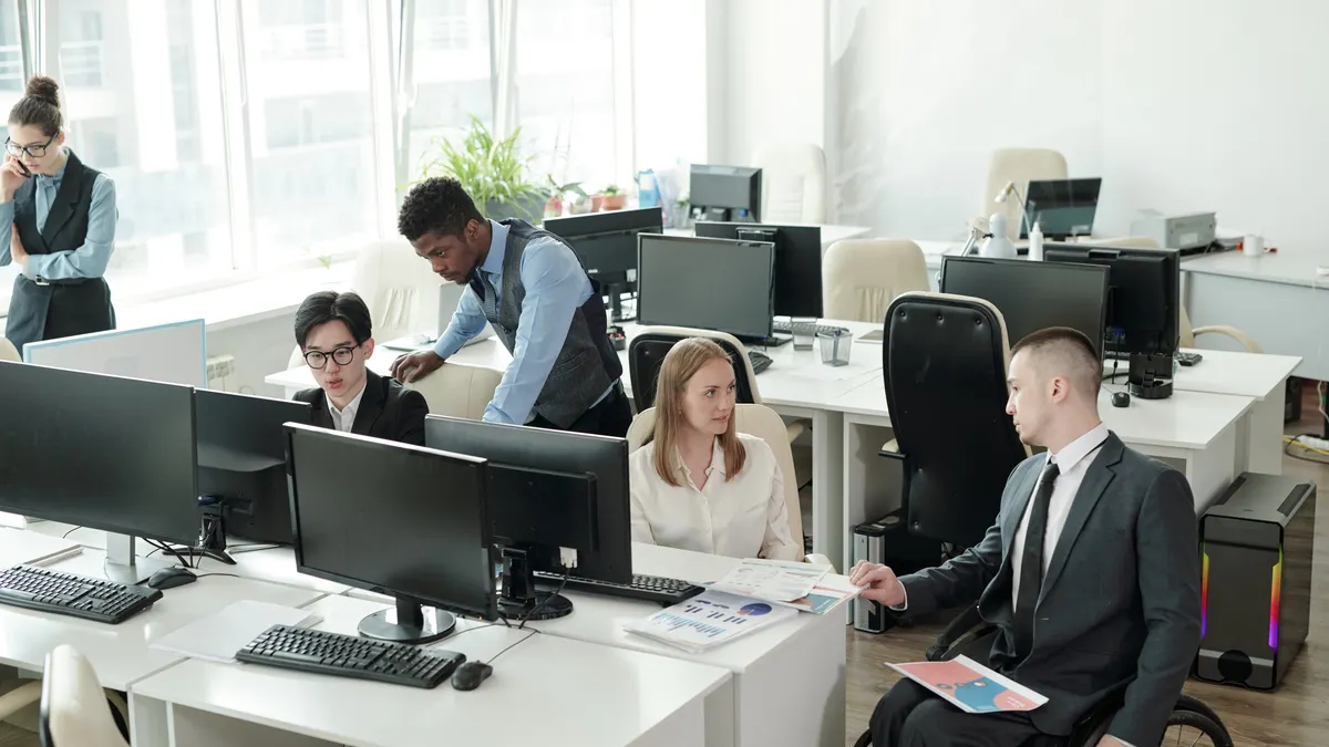 Two small groups of office managers working in teams