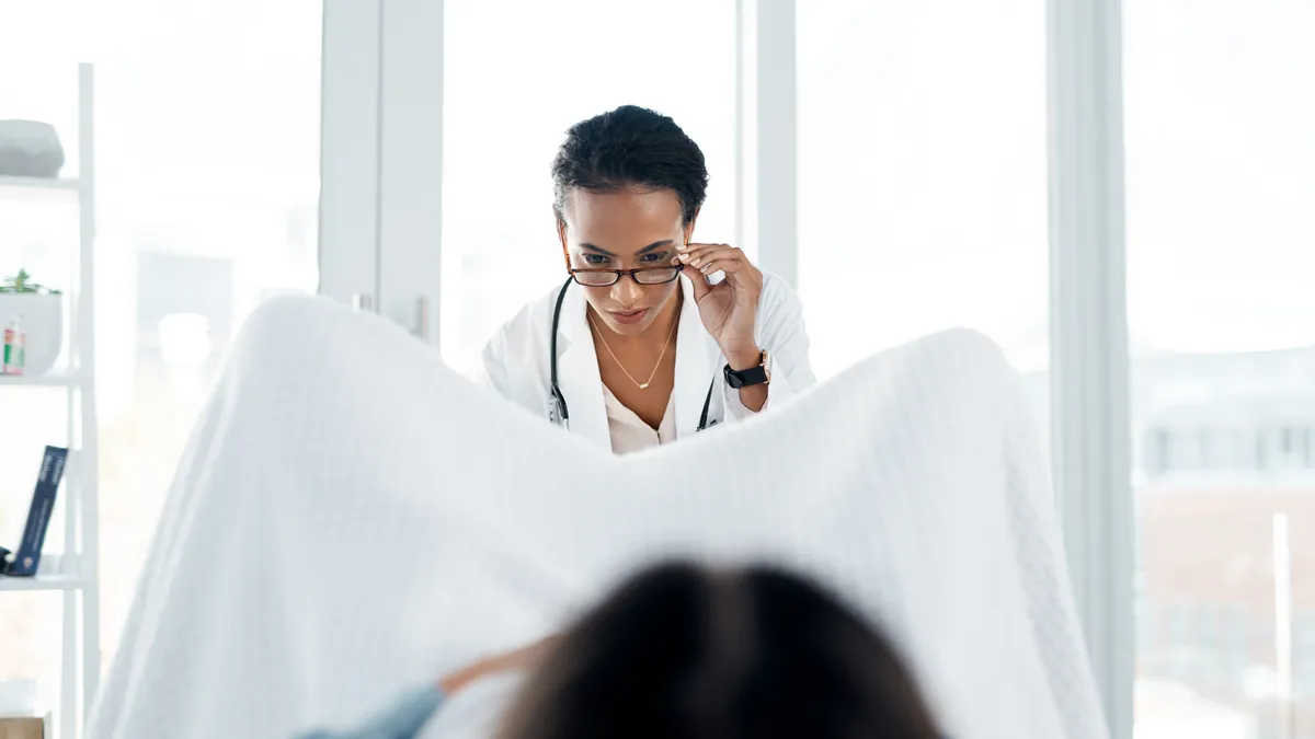 A woman in a medical setting with a gynecologist